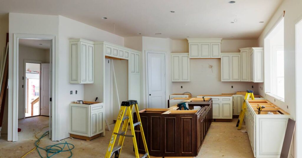 A kitchen remodel in the process of getting fitted for custom cabinetry installation, including a large island in the middle.