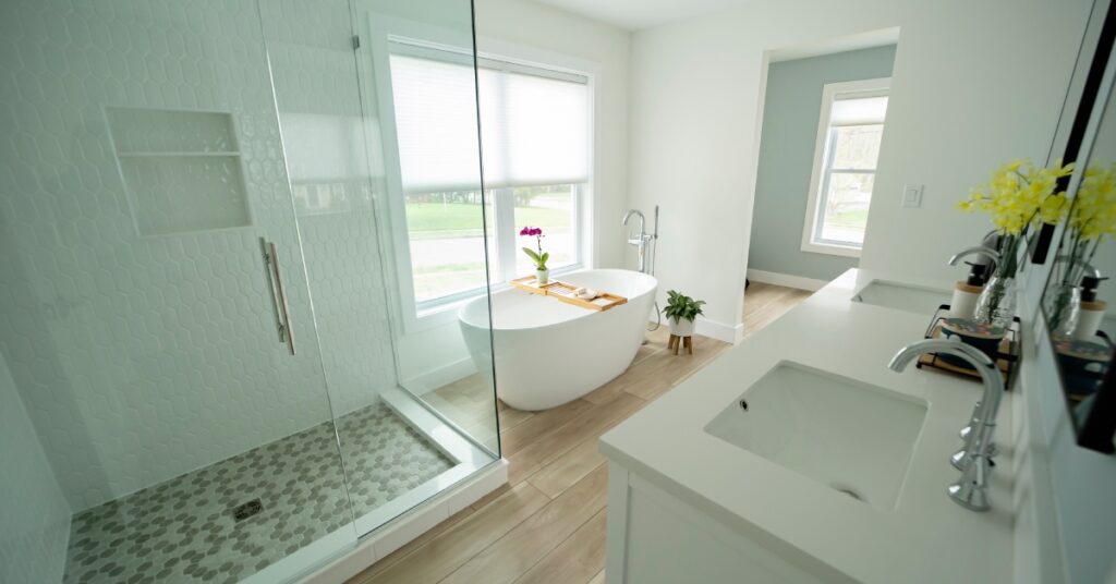 A newly renovated and modern home bathroom, boasting a soaking tub, walk-in shower, and double vanity.