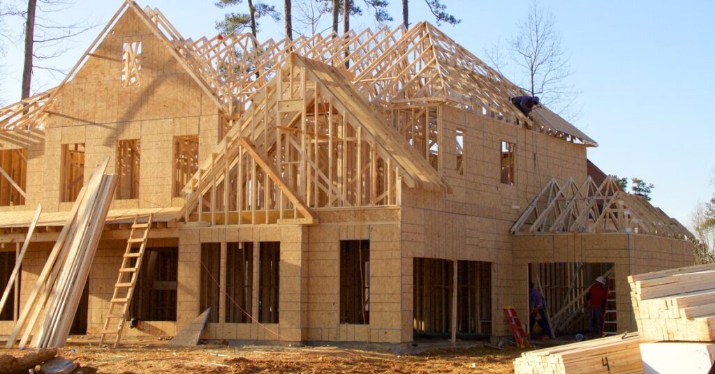 A custom-built home in the middle of the construction process—most of the frame and wall panels are constructed.