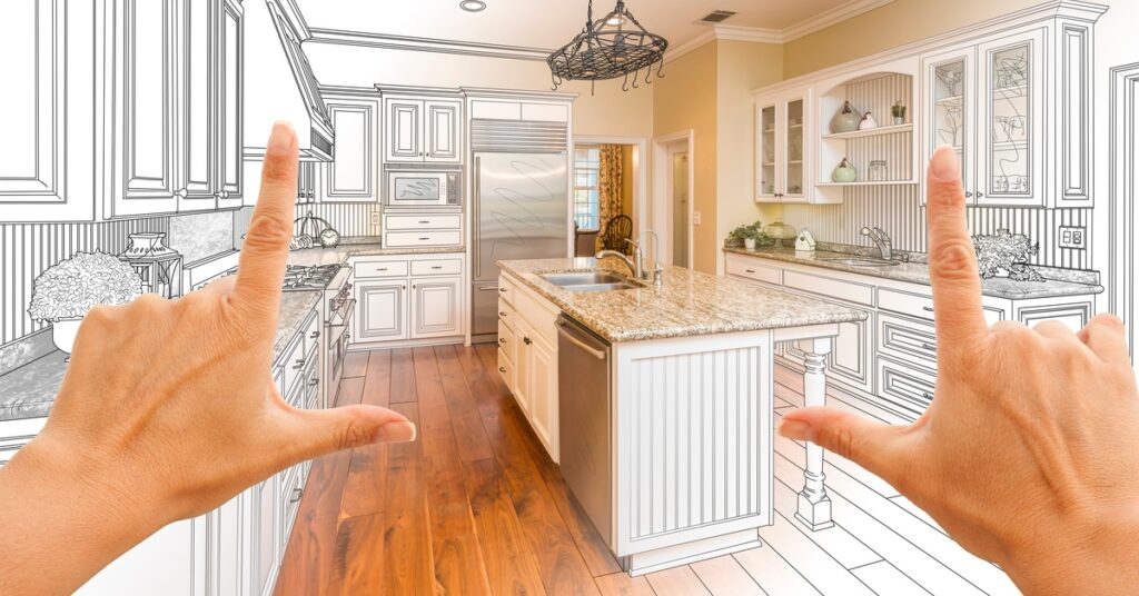 A pair of hands forming L-shapes in front of a half-built, half digitally sketched kitchen with wood floors.